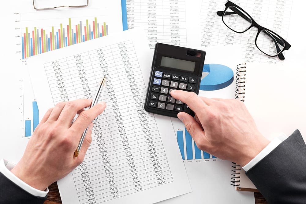 Small Business Valuations Melbourne Small Business Valuations Melbourne - Businessman working with using a calculator to calculate the numbers.